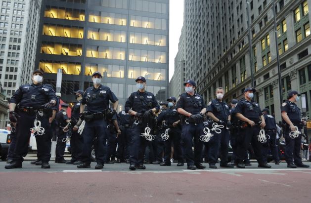 Police Officers watch over protesters during a rally over the death of George Floyd, a black man who was in police custody in Minneapolis Thursday, May 28, 2020, in New York. Floyd died after being restrained by Minneapolis police officers on Memorial Day. (AP Photo/Frank Franklin II